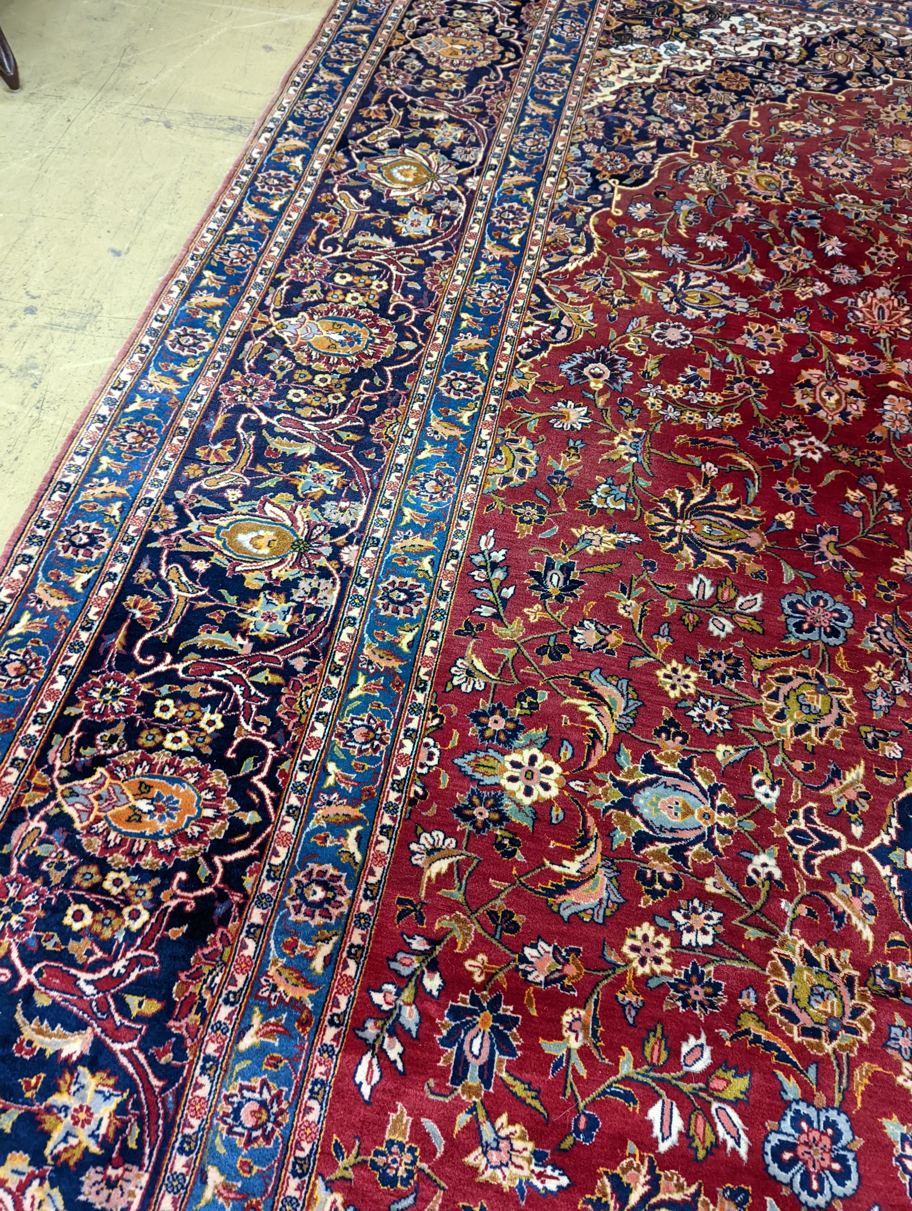 A large Tabriz red ground floral carpet, 540 x 350cm